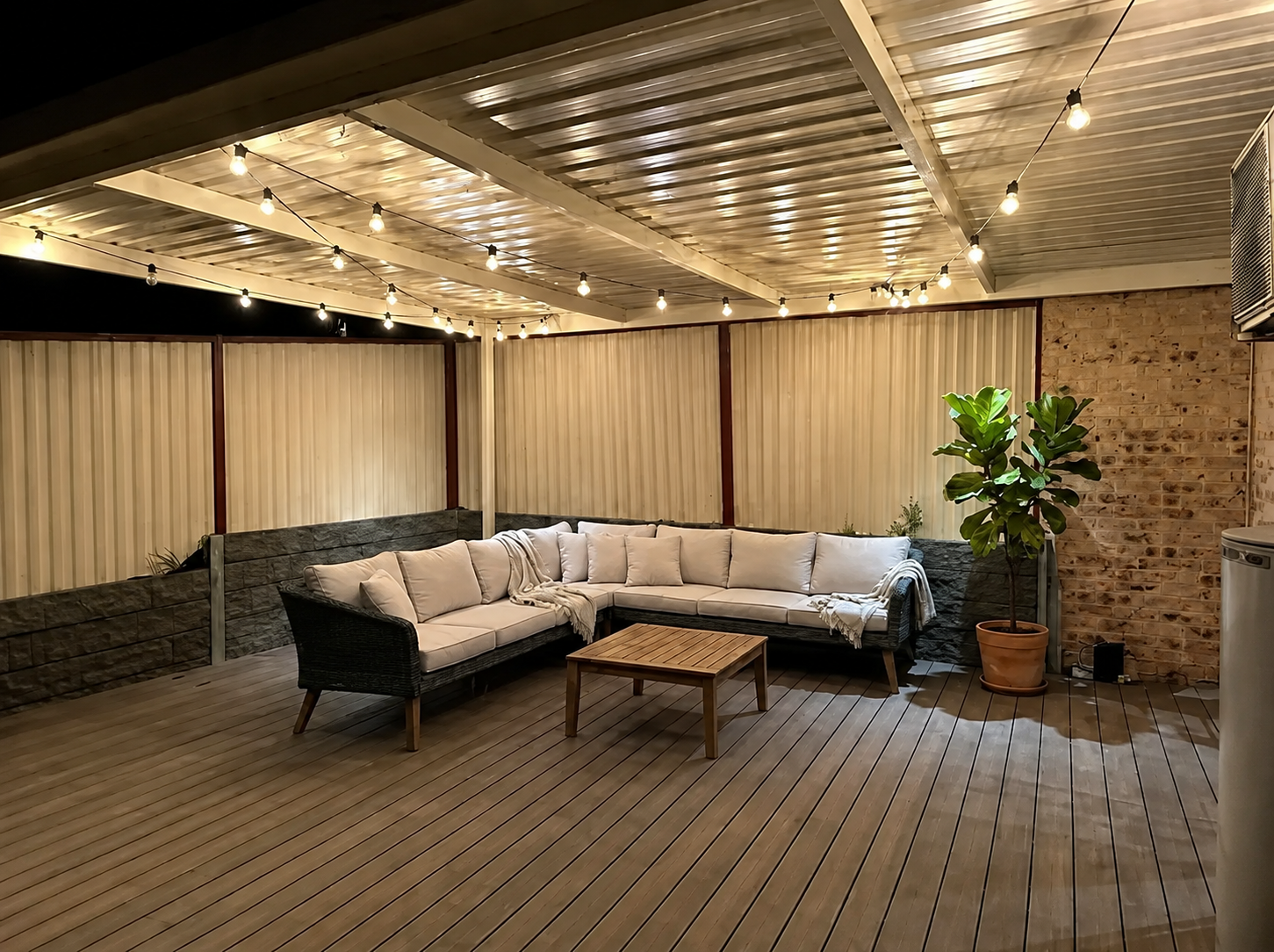 Festoon lights installed across a backyard entertaining area